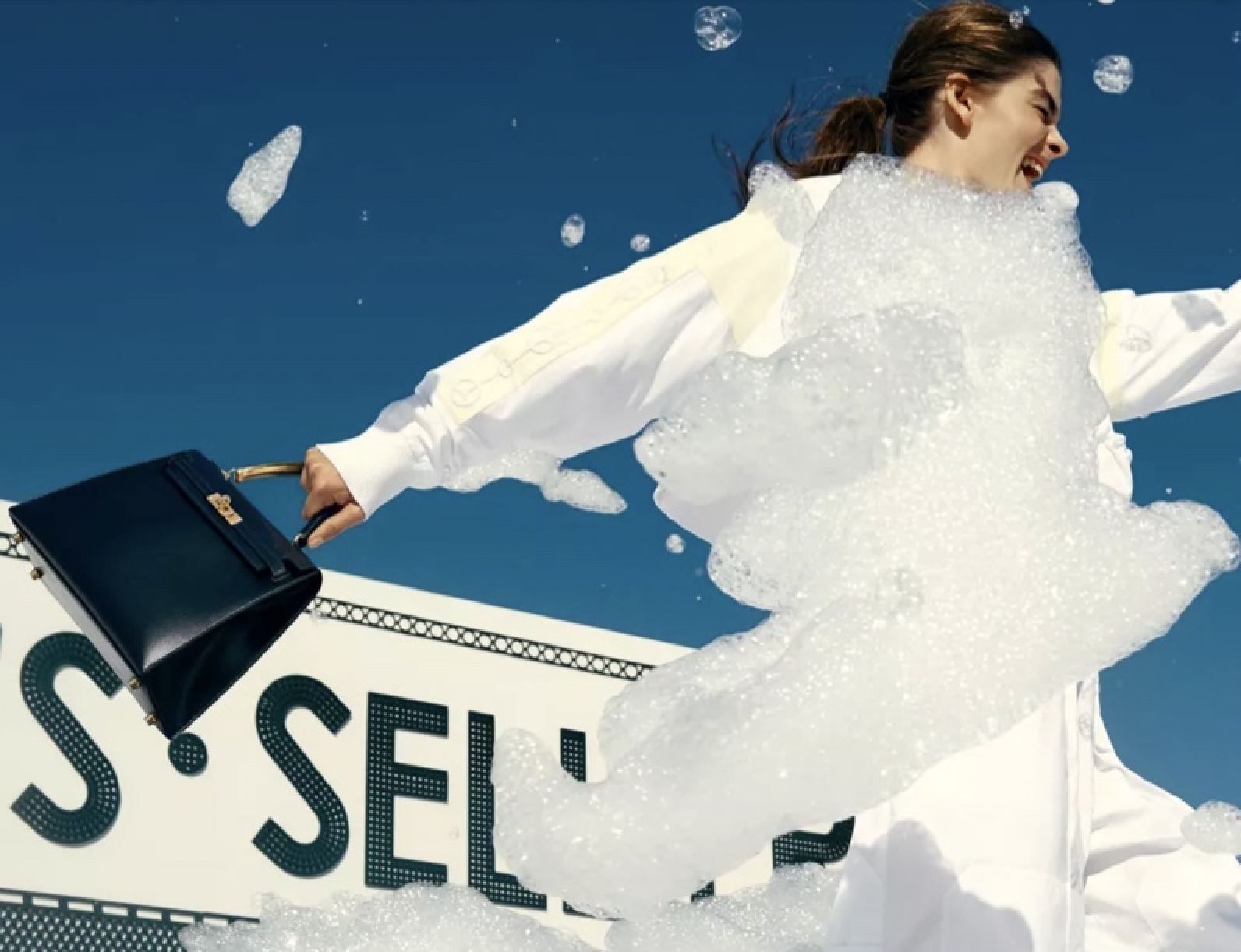 A model holding an Hermès handbag