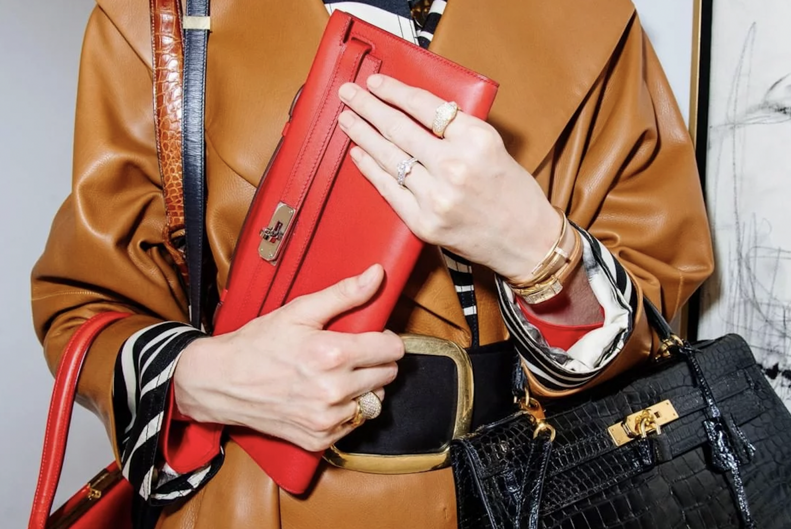 A woman holding Hermès bags