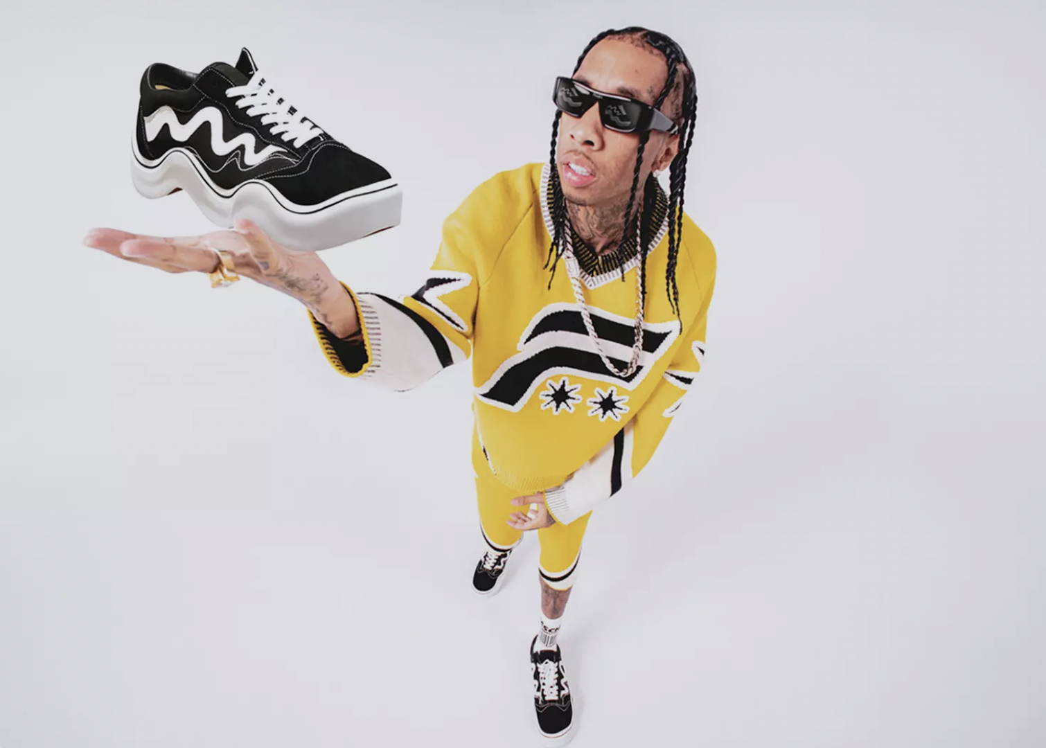 Tyga Holding MSCHF's Wavy Baby sneakers