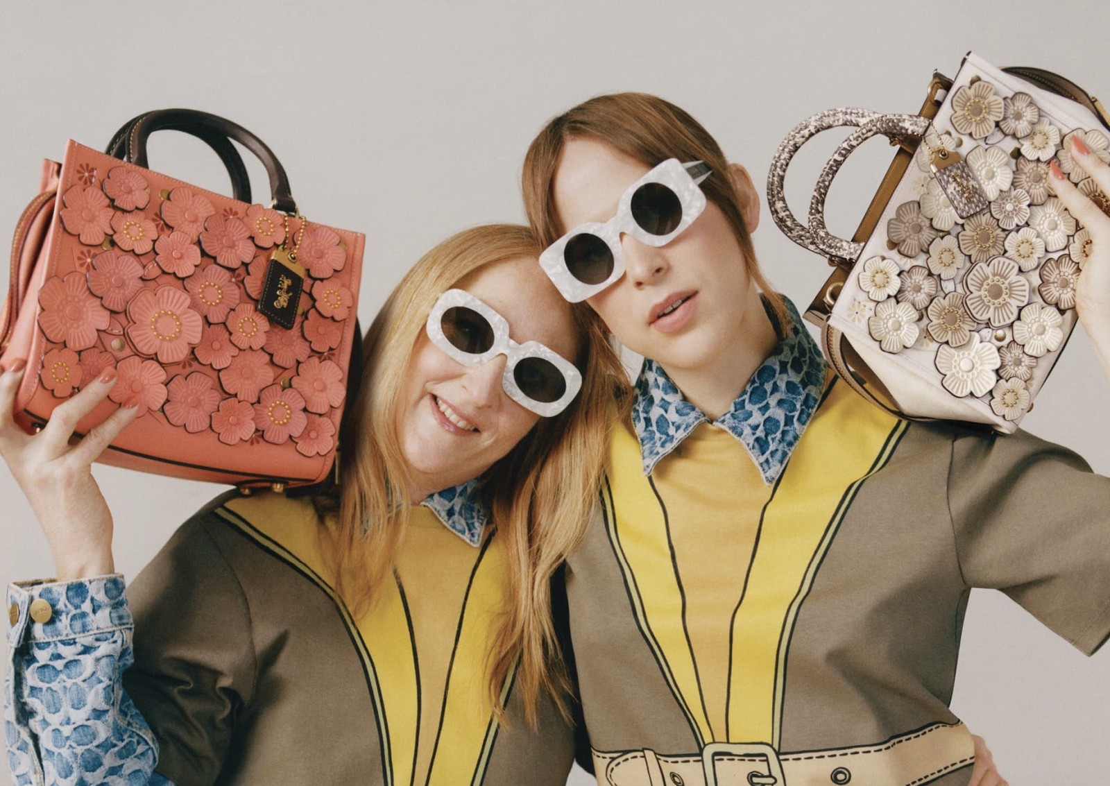 Two women holding handbags