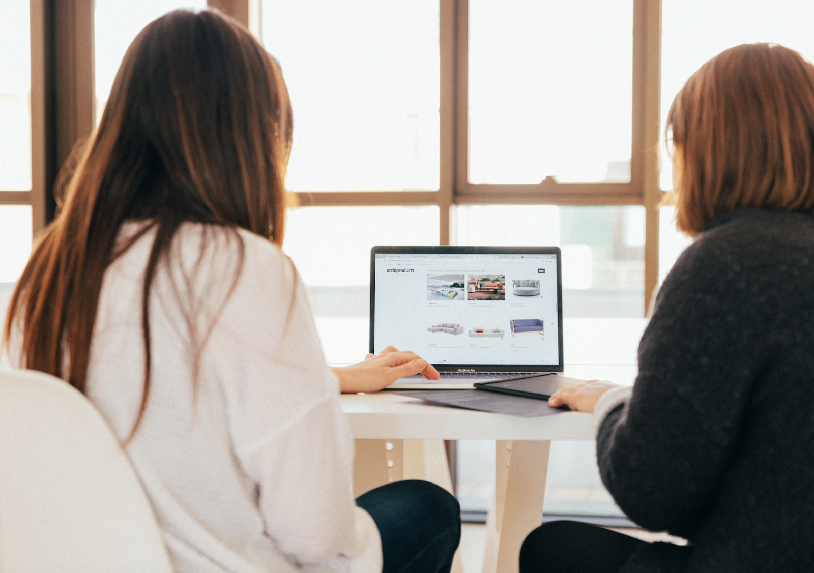 Two women looking at a laptop