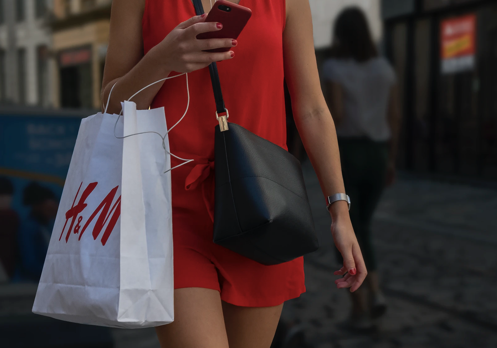 Woman carrying an H&M shopping bag