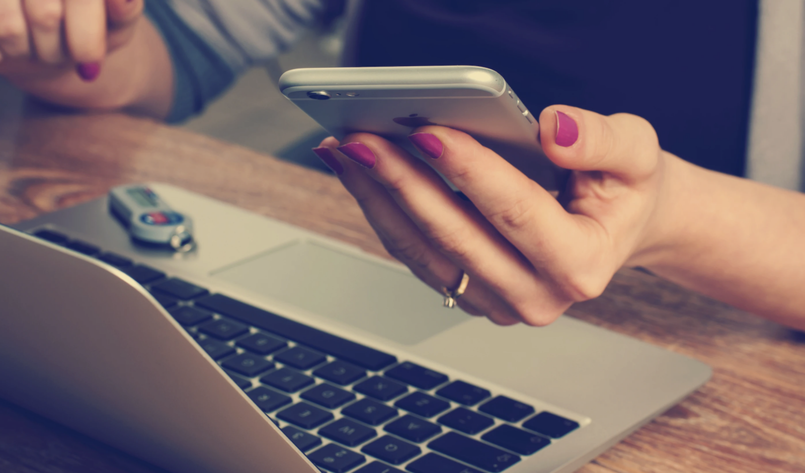 A woman's hand holding a cell phone